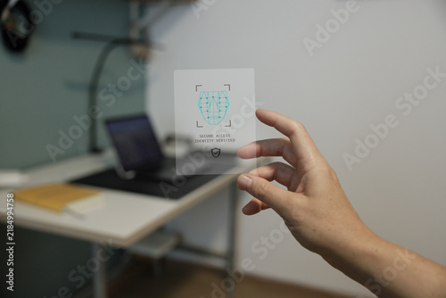 Fotografie Digital identity verification card held in modern home office
