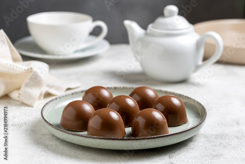 Gourmet Milk Chocolate Bonbons and Chocolate Truffles on Ceramic Plate