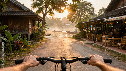 Cycling tropical village sunrise river palm wooden house outdoor travel adventure peaceful lush morning rural nature relaxation vacation leisure scenic tourism exploration journey lifestyle
