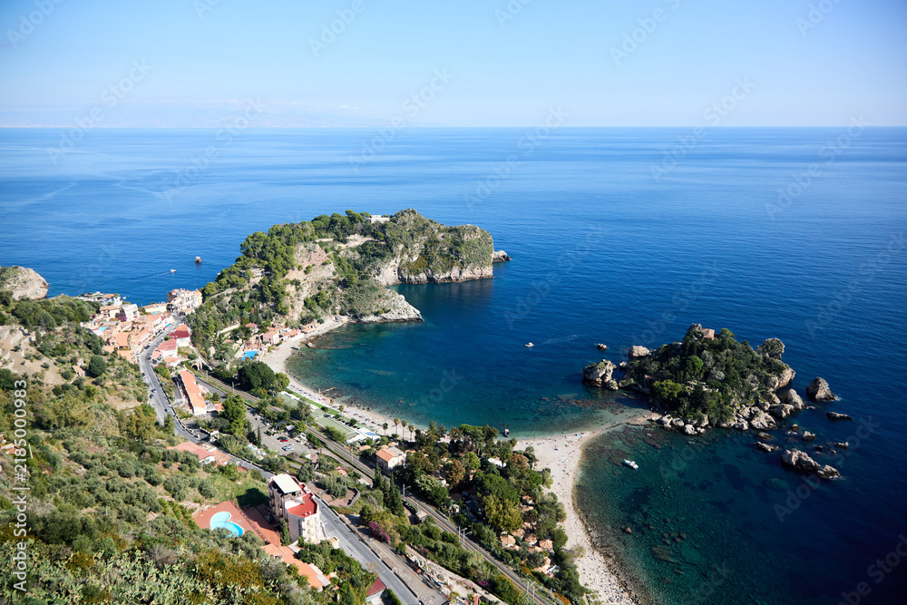 Fototapeta premium Aerial view of the stunning Isola Bella in Taormina, Sicily, showcasing its rocky shores, verdant vegetation, and crystal-clear turquoise waters
