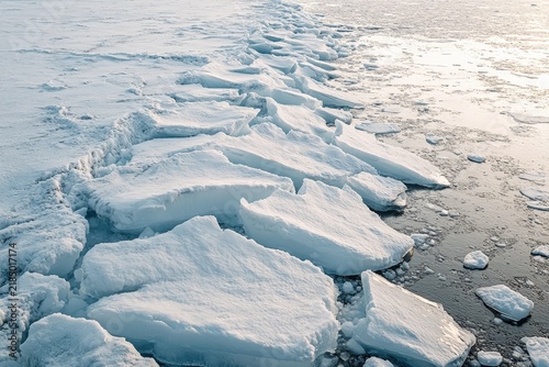 Frozen ice floes along a shoreline in winter.