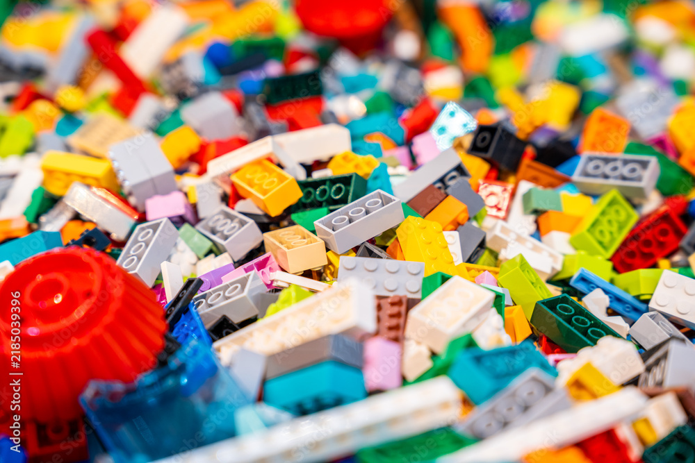 Obraz premium A pile of multicolor of many Lego toy blocks in various shapes and different sizes. Toys and games. Leisure and recreation.