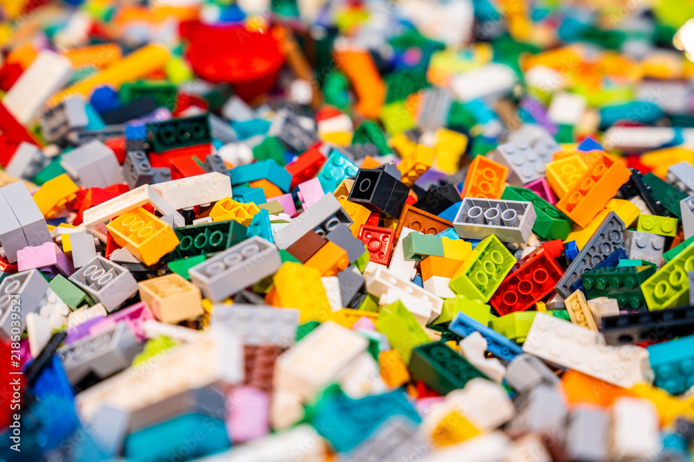 Obraz premium A pile of multicolor of many Lego toy blocks in various shapes and different sizes. Toys and games. Leisure and recreation.
