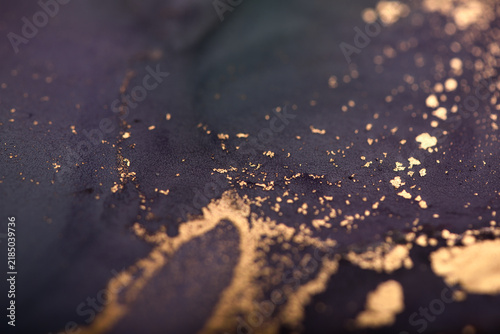 Abstract background of purple-green and gold stains. Photo of the surface.