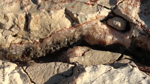 Kas, Turkey - 11 of March 2026: Viewing raw calcite crystal formation inside rock fissure
