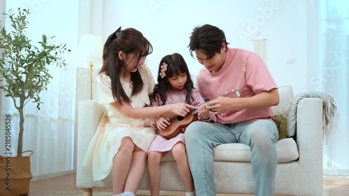 Family Enjoys Time Together While Playing Music in Their Living Room