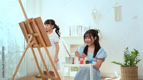 Girl Learns Painting With Mom in a Bright Room During the Afternoon Hours