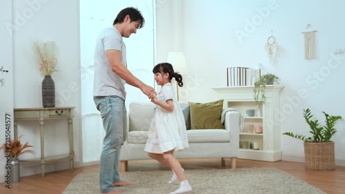 Father and Daughter Dancing Together at Home in a Bright Living Room