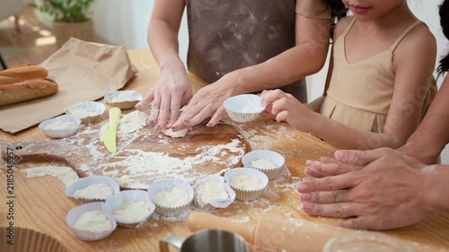 Family Cooking Together in a Kitchen While Making Dessert on a Weekend Morning