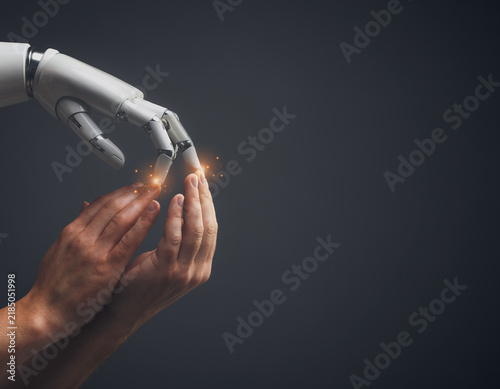 Naklejka ロボットハンドに触れる複数の人の手で表現したAIと人間の協働