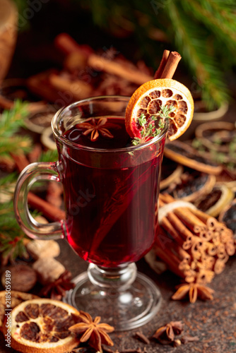 Konstfotografi Mulled wine with spices and dried citrus on a brown vintage background