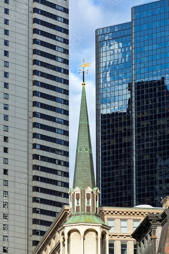 Historic Old South Meeting House steeple between modern skyscrapers in Boston, Massachusetts