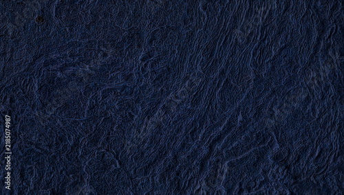 Dark navy blue rough handmade paper texture seamless background detail with organic fiber structure