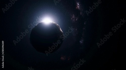 Rocky planet passes before a bright light source in deep space. Astronomy education, science documentary, and space exploration presentation.