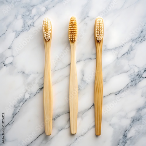 Three Eco Friendly Bamboo Toothbrushes Lined Up On A White Marble Surface dental