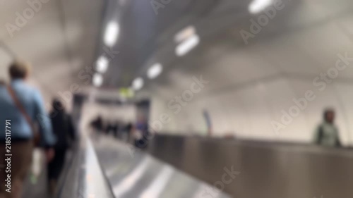 Blurred background of people walking on moving travelator - version 2