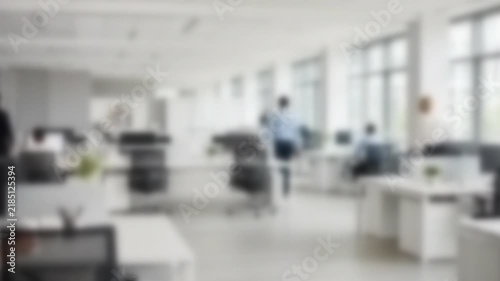 Two people greeting in a bright white office lobby, Full Gaussian Blur Abstract