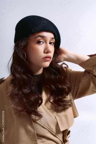 Obraz na plátně Young woman showcasing stylish fashion with flair and confidence
