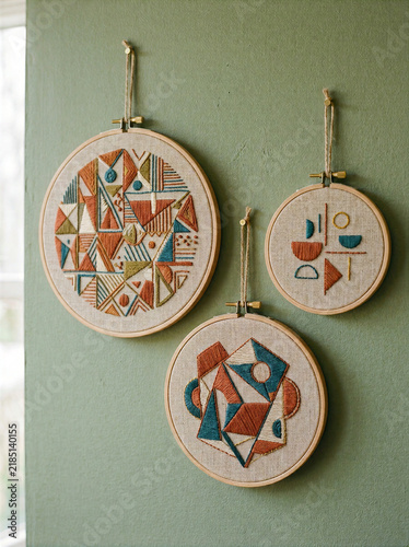 Handmade Geometric Embroidery Hoops Hanging on Sage Green Wall