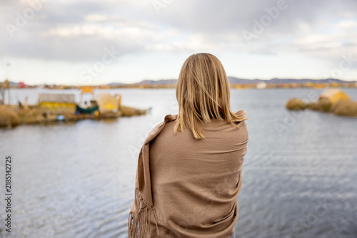 Bild auf Leinwand Rear view of woman standing by a quiet lake