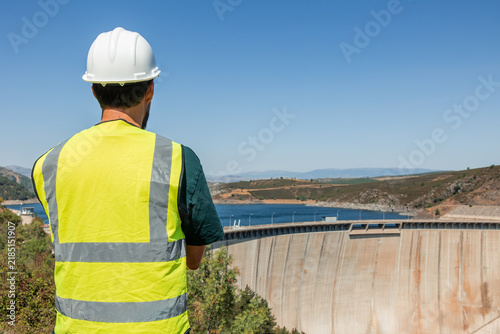 Engineer inspecting hydroelectric dam for renewable energy production