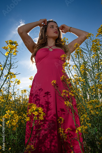 Woman in Fuchsia Dress Among Yellow Flowers