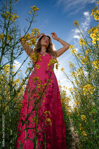 Woman in Fuchsia Dress Among Yellow Flowers