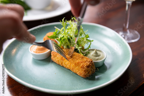 Bild auf Leinwand Deliciously Plated Crispy Croquettes With Vibrant Sauces at a Fine Dining Restau