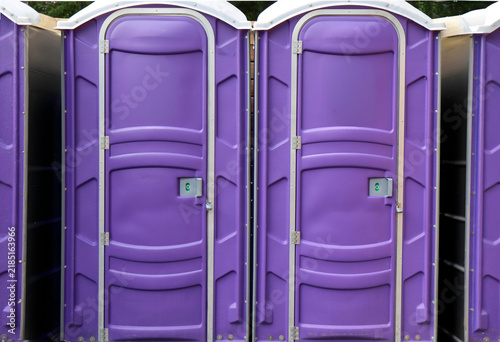 Two purple ports-potties standing side by side, nobody