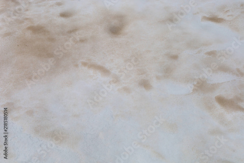 фотографія Dirty melting snow surface is covered with sandy and earthy patches