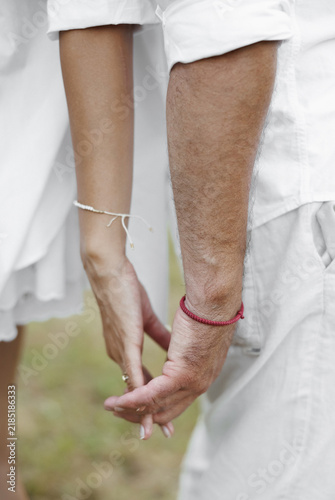 Obraz na plátne A close-up view of a loving couple gently holding hands, symbolizing profound co