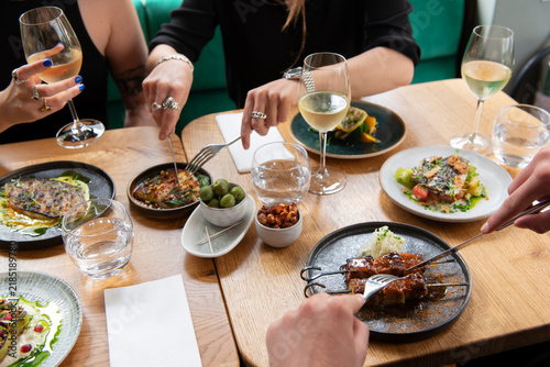 Delicious Evening Feast With Friends Showcasing Vibrant Dishes and Fine Wine