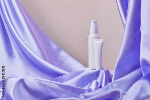 A container with cream for the care and maintenance of hygiene. Spa makeup. A tube of cream on a purple background.