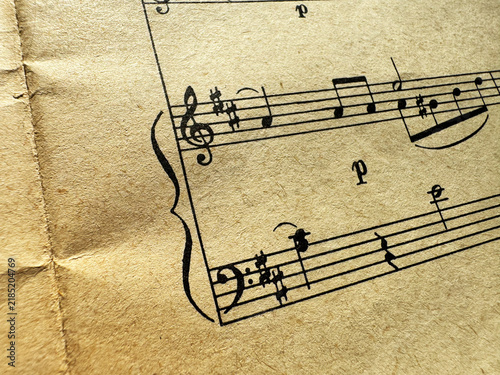 Obraz na plátně Close up of old sheet music with musical notes and clefs