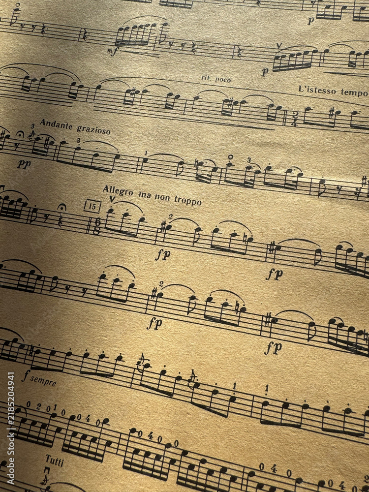 Fototapeta premium Close up of old sheet music with musical notes. Old musical score - no lyrics. Atmospheric music background with notes on old brown paper. For scrapbooking collage, journal design, and craft projects.