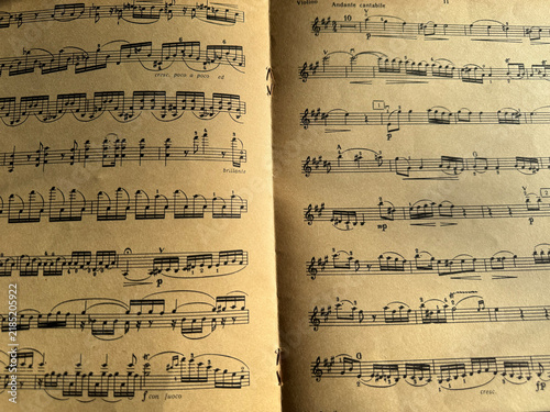 Close up of old sheet music with musical notes. Old musical score - no lyrics. Atmospheric music background with notes on old brown paper. For scrapbooking collage, journal design, and craft projects.