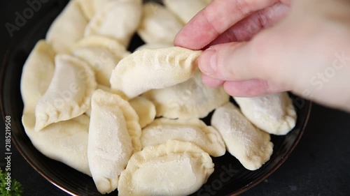 Vareniki handmade dumplings frozen product delicious appetizer, gourmet dish table setting food background rustic style dish, top view, text space