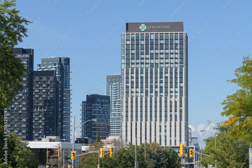 Fototapeta premium wide distant view of buildings at Leslie and Eglinton, including sign of Generations residential tower at Crosstown Community, 844 Don Mills Rd, Toronto