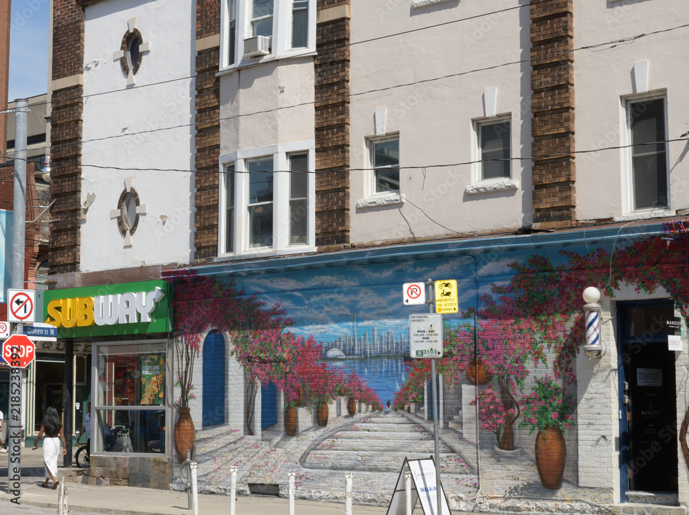 Obraz premium old apartment commercial block with mural and sign of Subway, a sandwich shop, located here at 267 Queen St W at Duncan St, Toronto