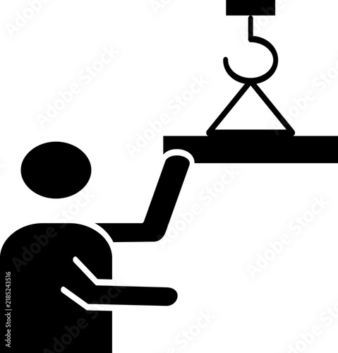 A construction worker guiding a heavy suspended beam attached to a crane hook.
