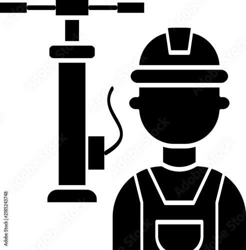 Technician or handyman wearing a safety hard hat helmet standing beside a manual piston air pump with hose