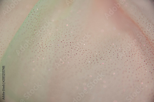 A delicate pastel background. A screen saver with fabric. A festive decoration. Light and bokeh. A greeting card for a wedding, engagement, or March 8. A template and copy space.