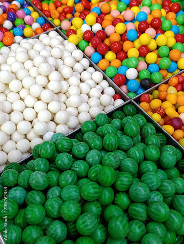 Bulk candy stall at a market shop, colorful loose sweets, gummy candies, sugar snacks, jelly candy and pick-and-mix treats displayed for sale by weight.