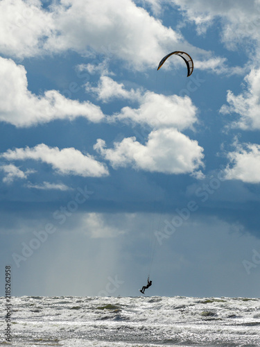 Canvastavla Kitesurfer Jumping Above Rough Baltic Sea Waves Under Dramatic Blue Sky and Larg