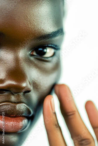 A person holds a cell phone to their ear, likely in conversation. vertical frame
