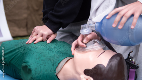 Fotografía Hands performing cardiopulmonary resuscitation on CPR training mannequin with re