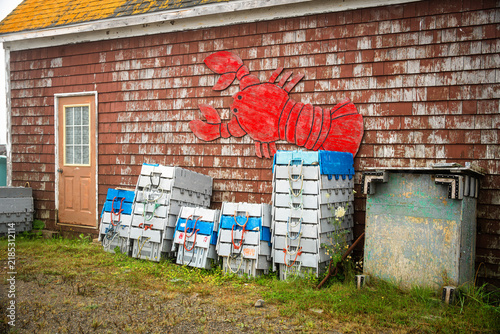 Foto Red lobster wall decoration above stacked fishing crates on a weathered wooden h
