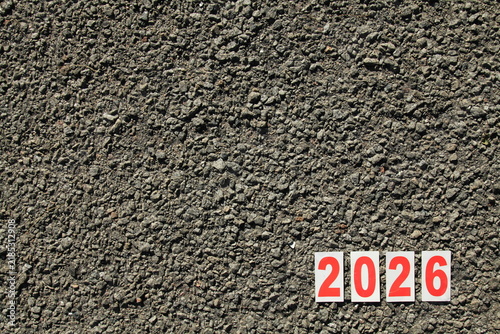 Numbers of 2026 year. Paper square numbers on the stone road background. Year of 2026, year of the red fire horse