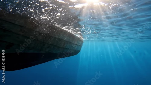 Underwater view of a boat in clear water during the day