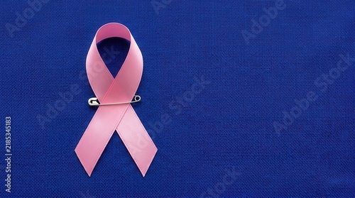 Symbol Of Hope Pink Ribbon With Pin On Blue Background
